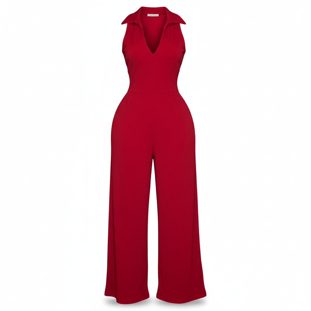 Woman in a red jumpsuit standing in front of a door.