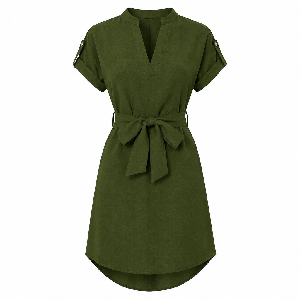 Woman wearing a green dress with a belt on a white background