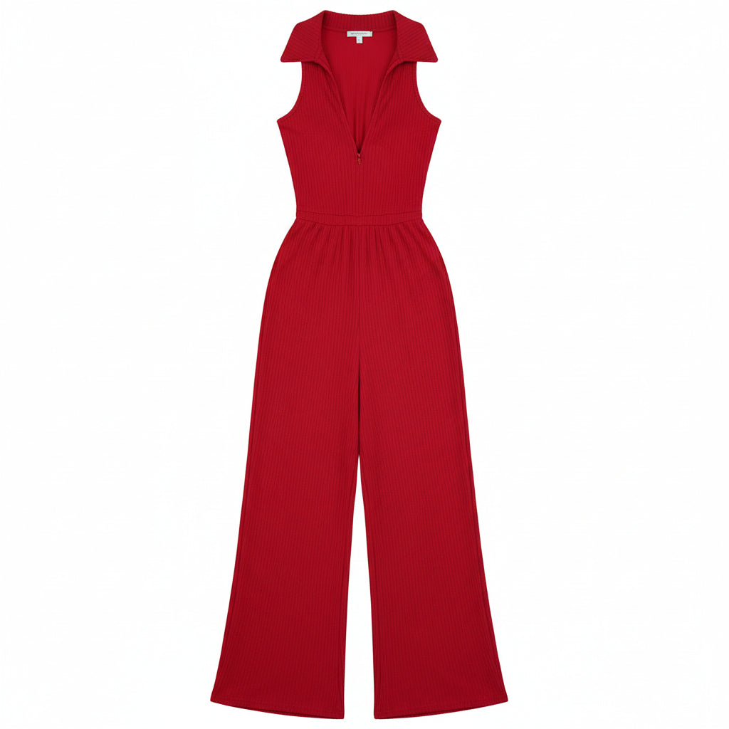 Woman in a red jumpsuit standing in front of a door.