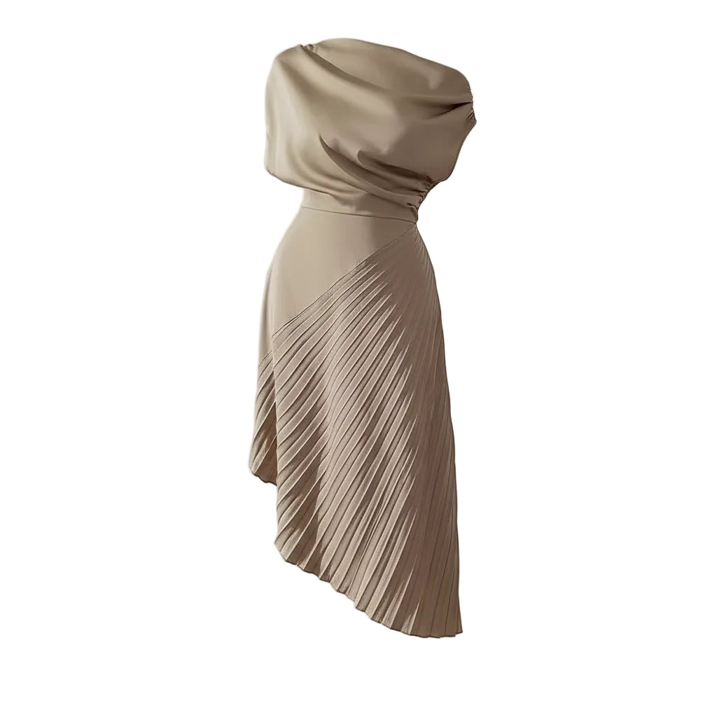 Woman wearing a beige one-shoulder pleated dress against a white wall.