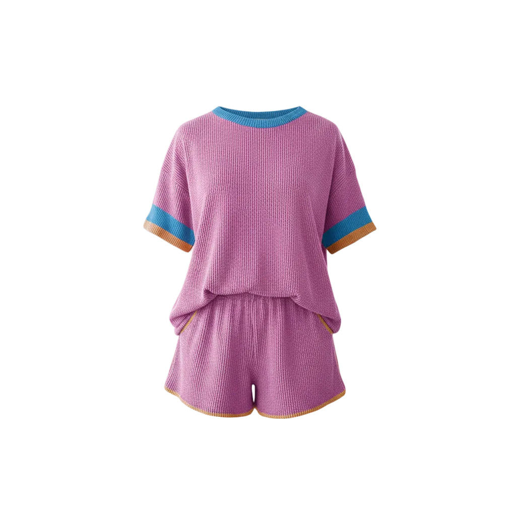 Woman wearing a pink knitted outfit with blue trim on a white background