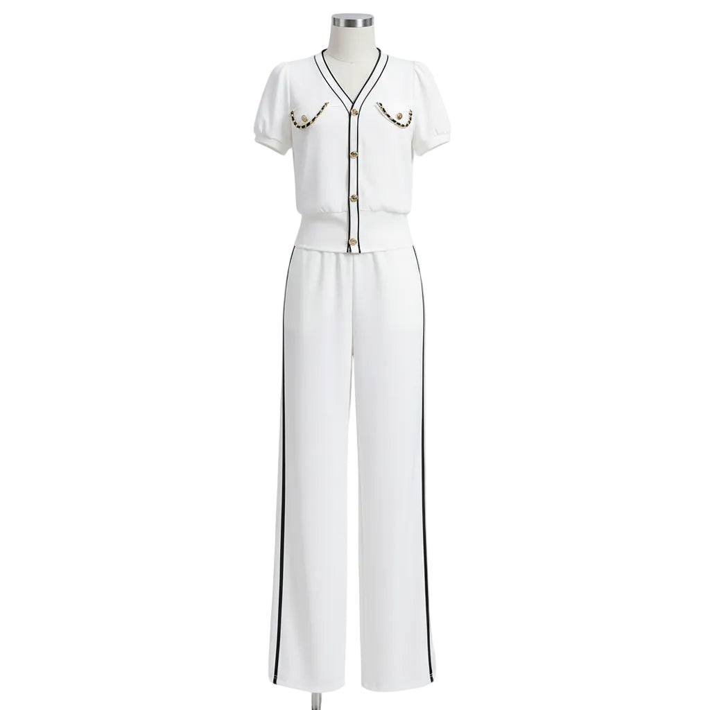 Person wearing a white outfit with black accents in a modern room.