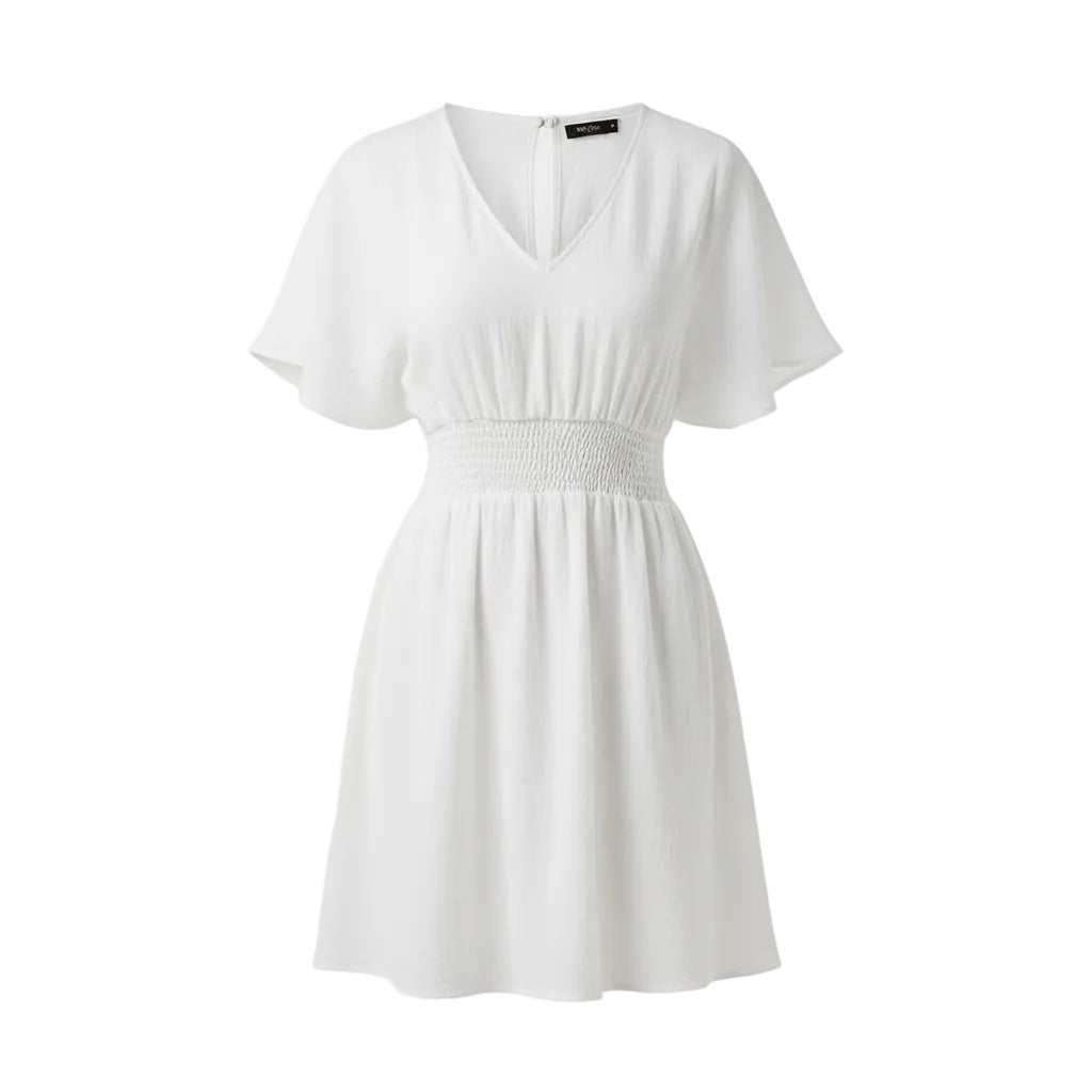 Woman wearing a white dress with a plain background